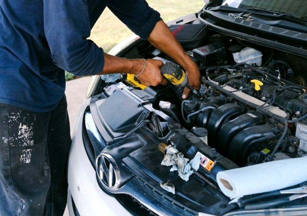 Tulsa mechanic working a no start under a carport