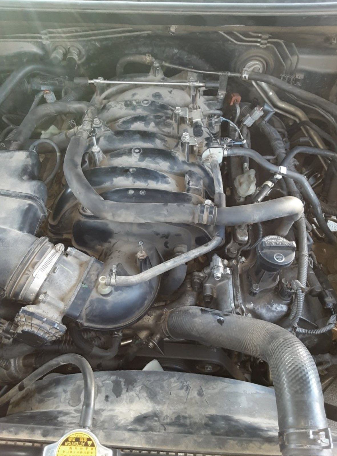 Hoses and cooling plumbing checked in a Tulsa engine bay
